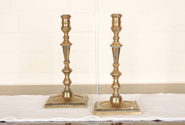 A PAIR OF BRASS CANDLESTICKS