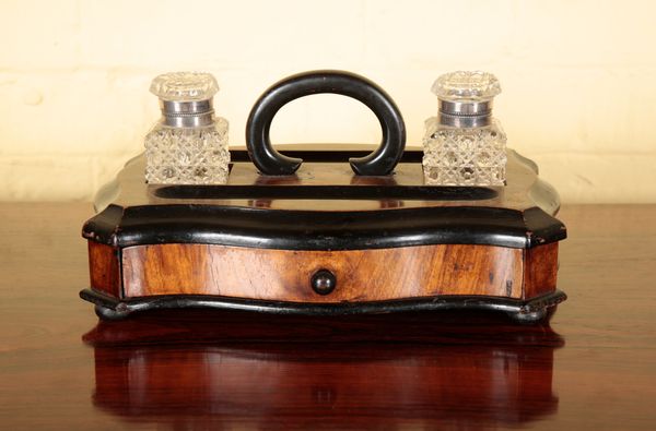 A VICTORIAN WALNUT AND EBONISED SERPENTINE STANDISH