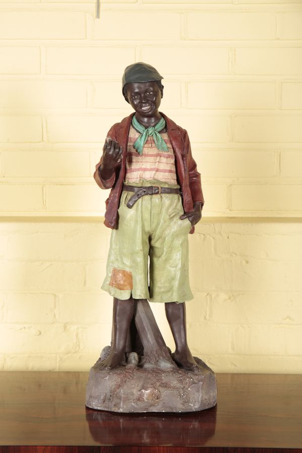 AN AUSTRIAN PAINTED TERRACOTTA FIGURE OF A BOY IN THE MANNER OF GOLDSCHEIDER