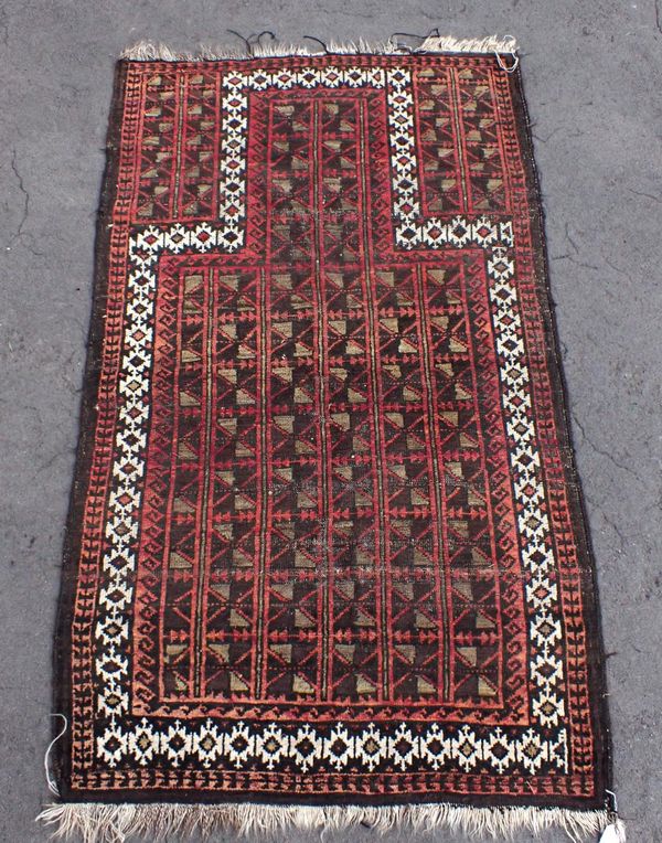 AN ANTIQUE BELOUCH PRAYER RUG