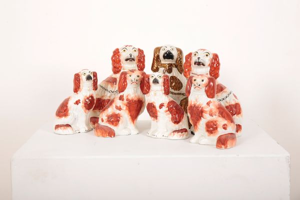 A PAIR OF 19TH CENTURY STAFFORDSHIRE POTTERY SPANIELS