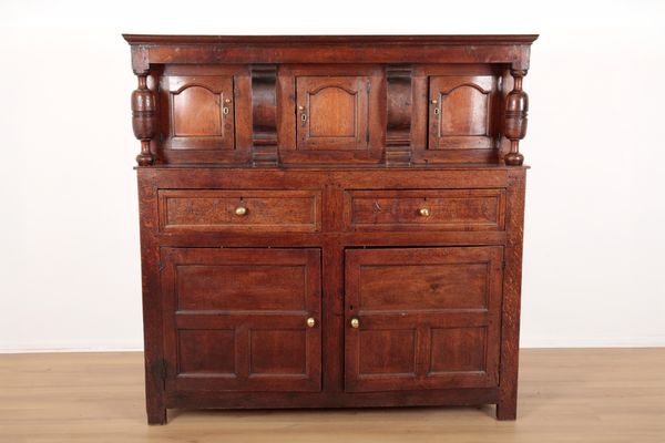 A PANELLED OAK COURT CUPBOARD