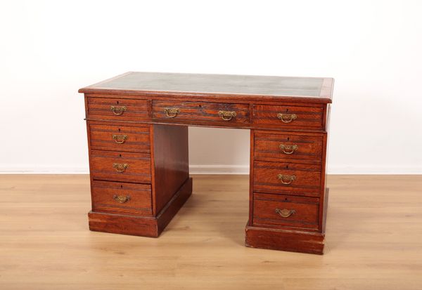 A LATE VICTORIAN OAK PEDESTAL DESK