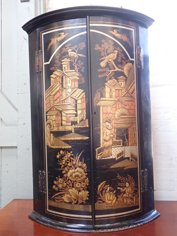 A JAPANNED BOWFRONT HANGING CORNER CUPBOARD