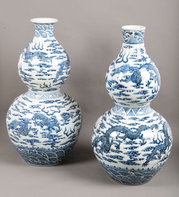 AN IMPRESSIVE NEAR PAIR OF CHINESE BLUE AND WHITE DOUBLE GOURD VASES
