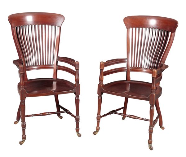 A PAIR OF EDWARDIAN MAHOGANY ARMCHAIRS IN THE MANNER OF E. W. GODWIN
