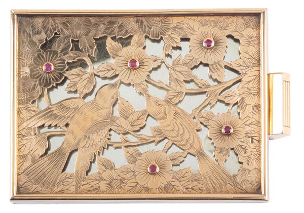 BOUCHERON: A SILVER AND SILVER GILT POWDER COMPACT SET WITH RUBIES