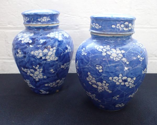 A NEAR PAIR OF CHINESE BLUE AND WHITE PORCELAIN LIDDED JARS