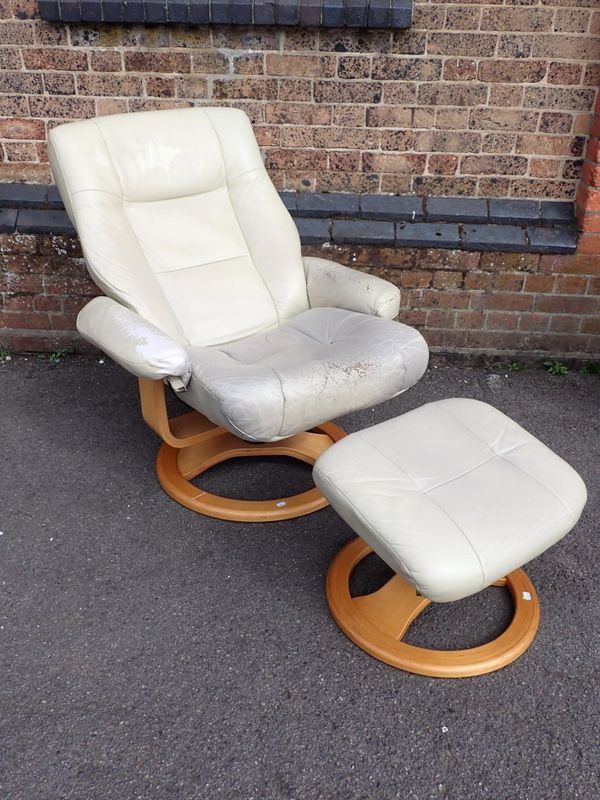 A 'STRESSLESS' STYLE CHAIR AND STOOL