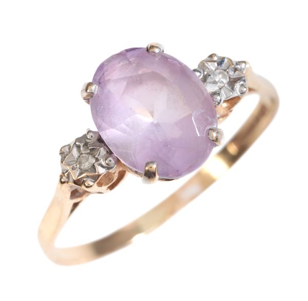 AN AMETHYST AND DIAMOND THREE STONE RING