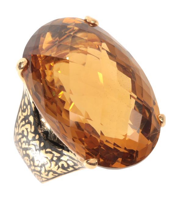 A LARGE CITRINE AND ENAMEL COCKTAIL RING