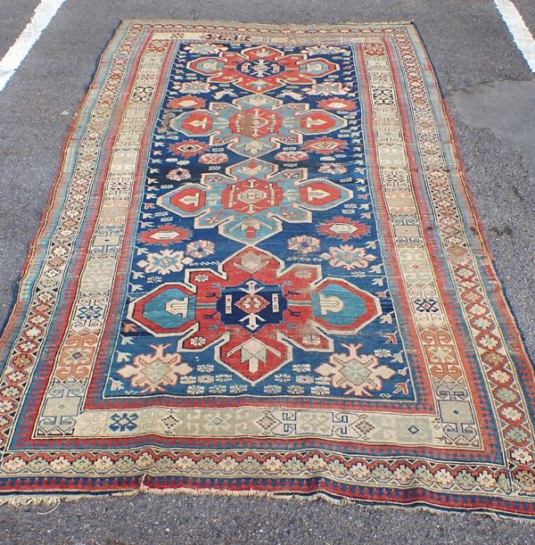 AN ANTIQUE KAZAK RUG, WITH MURGLI MOTIFS