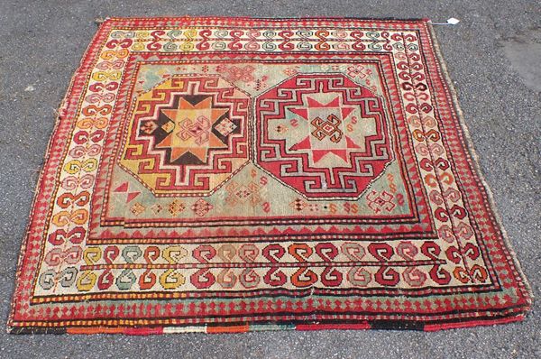 AN ANTIQUE KAZAK RUG