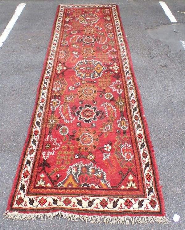 A RED GROUND BELOUCH TRIBAL RUNNER