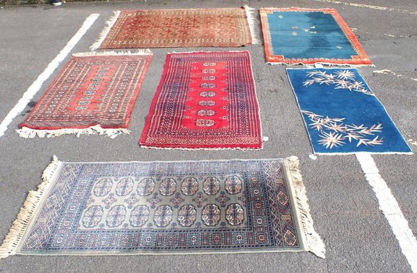 THREE RED GROUND RUGS