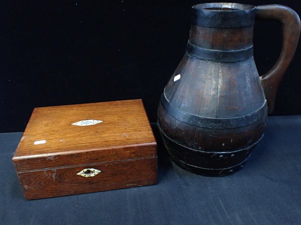 A COOPERED OAK BEER JUG