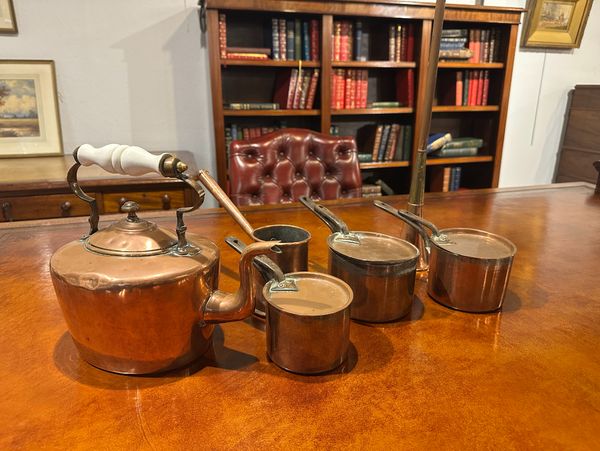 A COPPER KETTLE WITH CERAMIC HANDLE