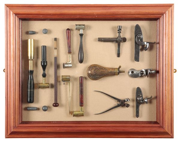 A DISPLAY CASE CONTAINING VARIOUS SHOOTING TOOLS