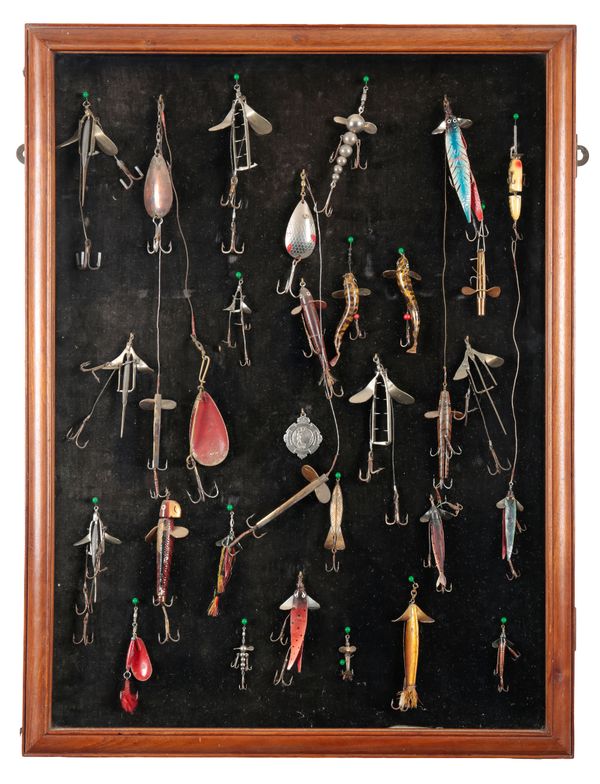 A DISPLAY CASE CONTAINING A LARGE COLLECTION OF LURES