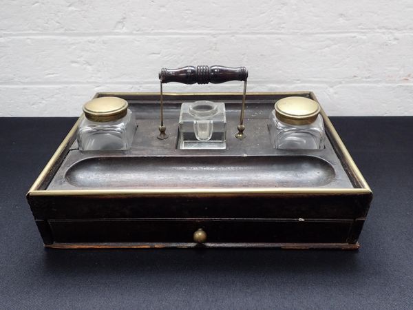 A ROSEWOOD AND BRASS DESK STAND WITH INKWELLS