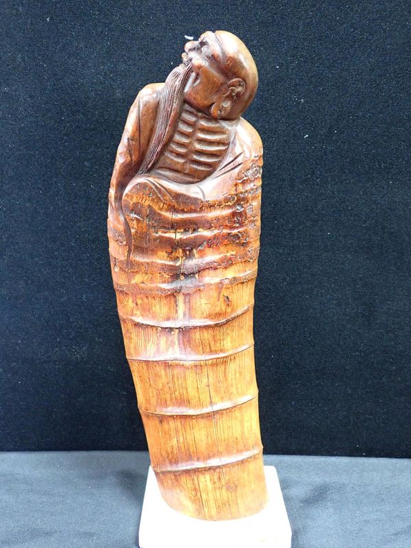 A CHINESE CARVED BAMBOO FIGURE OF CLOAKED LOHAN