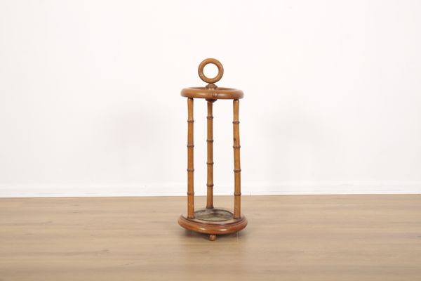 A CIRCULAR STICK AND UMBRELLA STAND