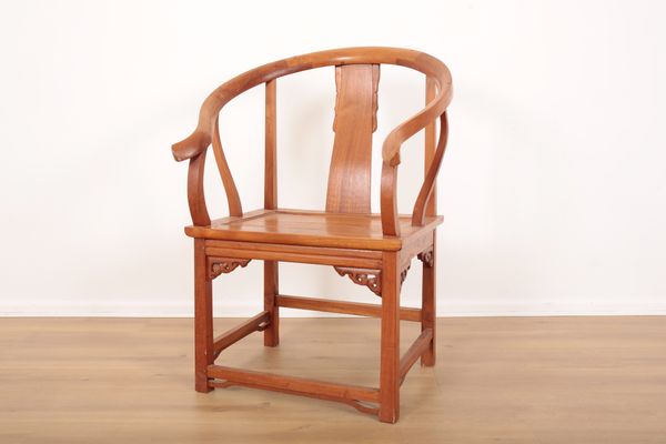 A CHINESE HARDWOOD HORSESHOE ARMCHAIR