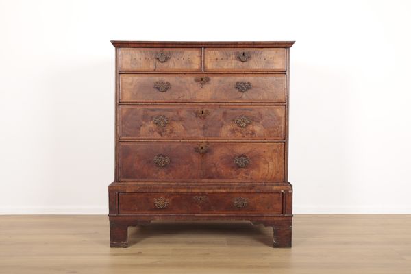 A FIGURED WALNUT CHEST ON CHEST