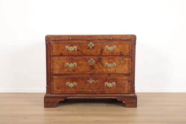 A WALNUT CHEST OF DRAWERS