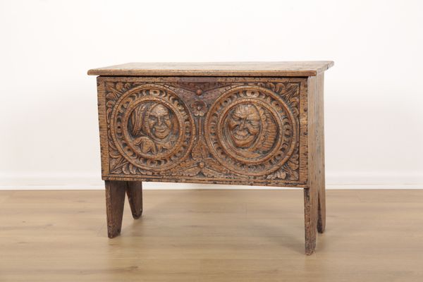 A CARVED OAK SIX PLANK COFFER OR CHEST