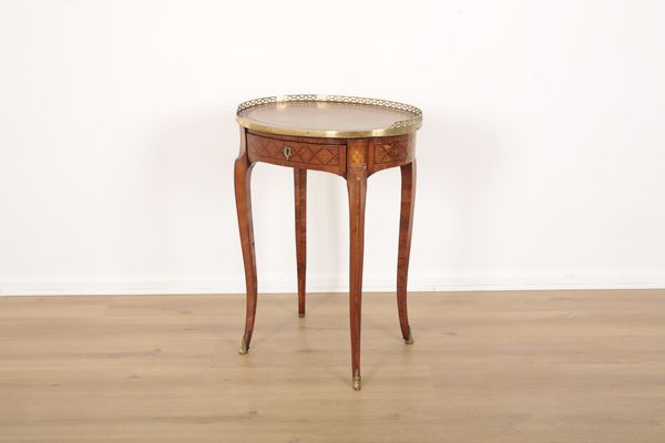 A LOUIS XV STYLE EXOTIC WOOD AND MARQUETRY INLAID OVAL TABLE OR DESK