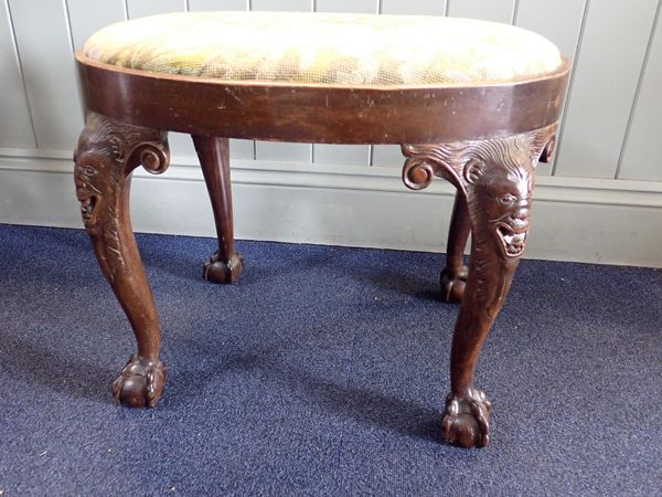 A WALNUT OVAL STOOL, ON CABRIOLE LEGS