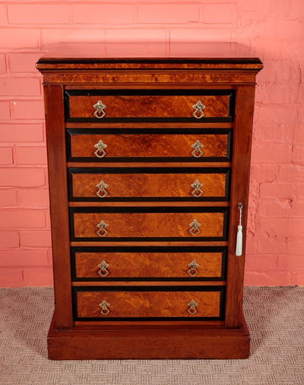 A VICTORIAN AMBOYNA AND EBONY BANDED WELLINGTON CHEST