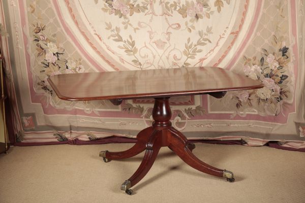 A REGENCY MAHOGANY DINING TABLE