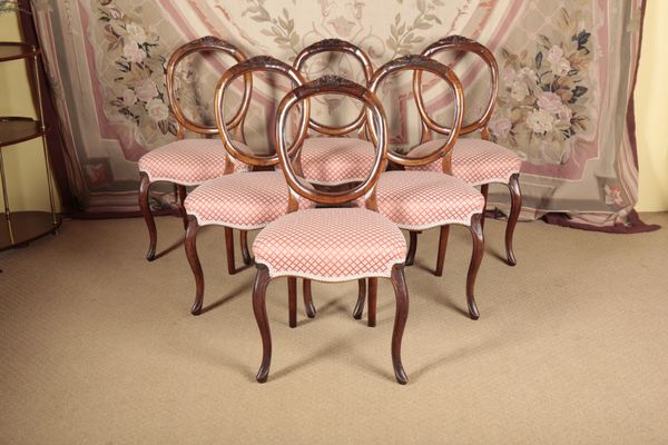 A SET OF SIX VICTORIAN WALNUT BALLOON BACK DINING CHAIRS