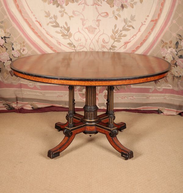 A VICTORIAN AMBOYNA, EBONISED AND GILT METAL MOUNTED CENTRE TABLE STAMPED GILLOWS