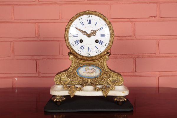 A FRENCH GILT METAL MANTEL CLOCK BY POTONIE OF PARIS