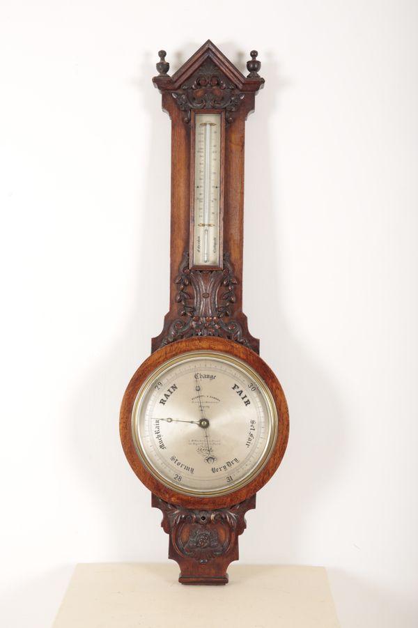 A VICTORIAN OAK WHEEL BAROMETER