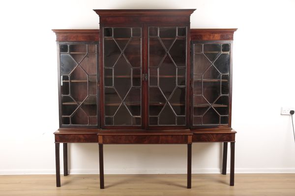 A BREAKFRONT MAHOGANY BOOKCASE ON STAND