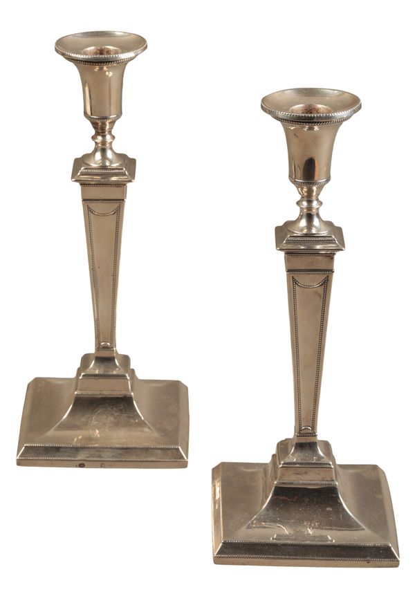 A PAIR OF GEORGE III SILVER CANDLESTICKS