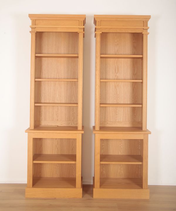 A PAIR OF LIGHT OAK BREAKFRONT BOOKCASES