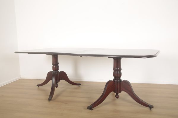 A MAHOGANY TWIN PEDESTAL DINING TABLE