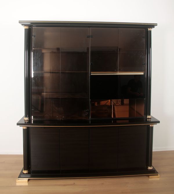 A 1980’S BLACK RESIN AND GILT METAL WALL UNIT IN THE MANNER OF PIERRE VANDEL