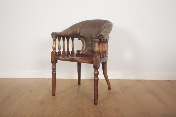 A WALNUT AND LEATHER COVERED 'CAPTAIN'S' CHAIR