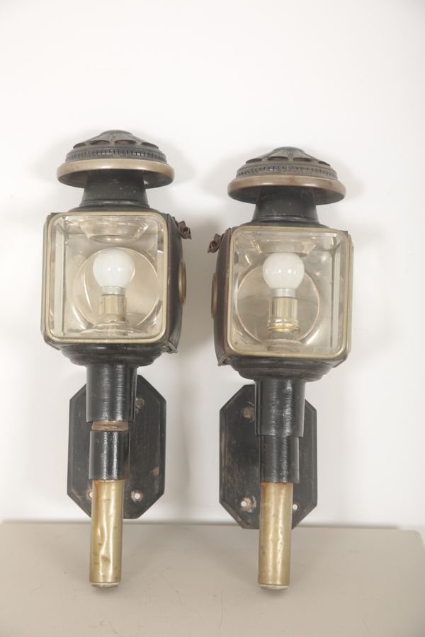 A PAIR OF EBONISED METAL COACHING LAMPS