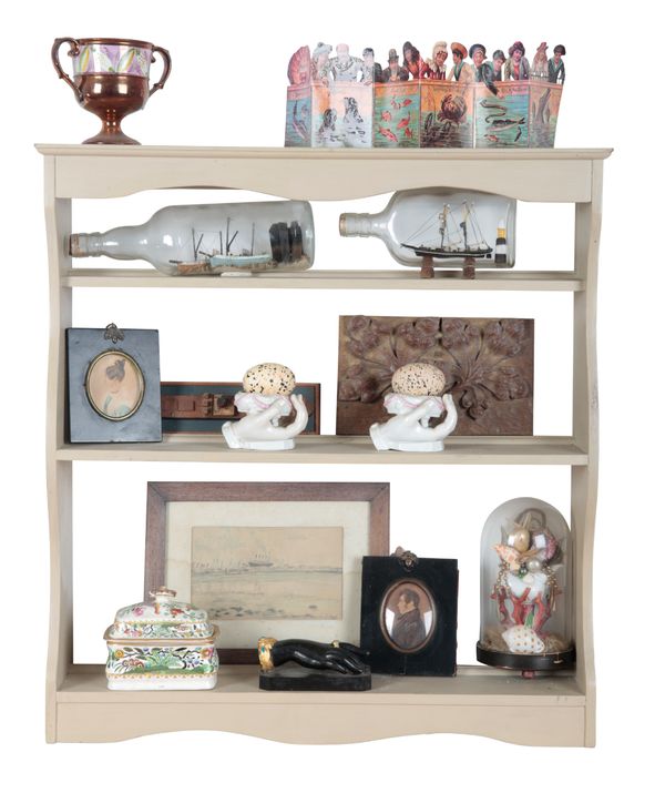 AN EDWARDIAN CREAM-PAINTED WALL MOUNTED OPEN FRONT BOOKCASE