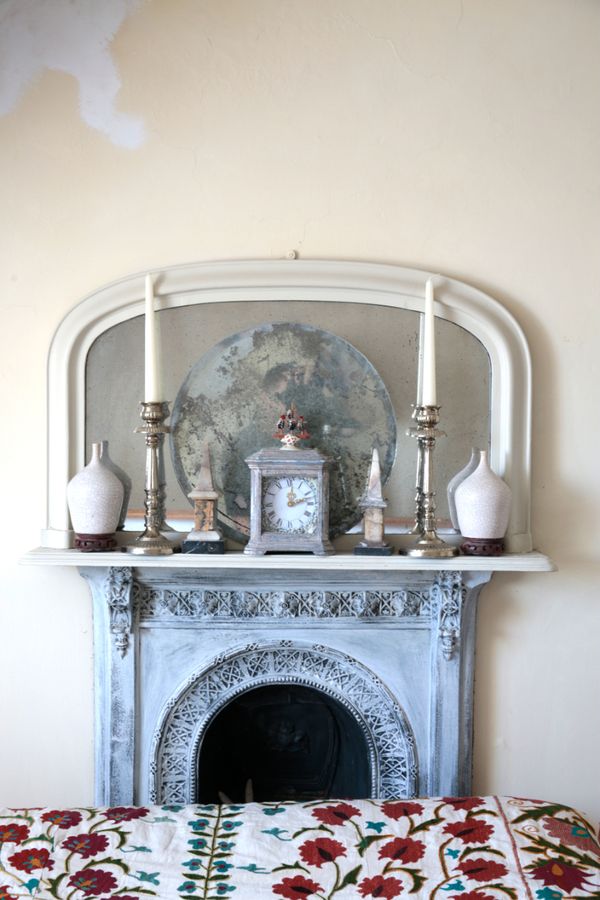 A 19TH CENTURY CREAM-PAINTED ARCH TOP OVERMANTEL MIRROR
