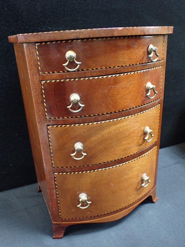 A MINIATURE MAHOGANY BOWFRONT CHEST OF DRAWERS