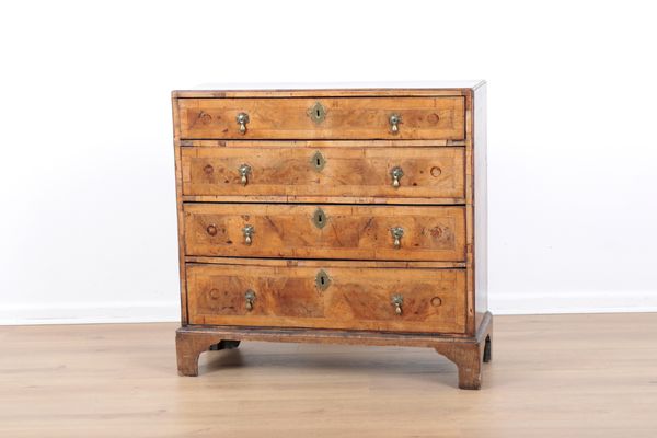 AN OAK CHEST OF DRAWERS