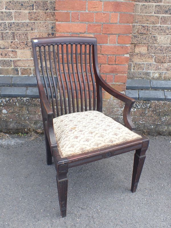 AN AESTHETIC MOVEMENT WALNUT ARMCHAIR IN THE MANNER OF E.W. GODWIN